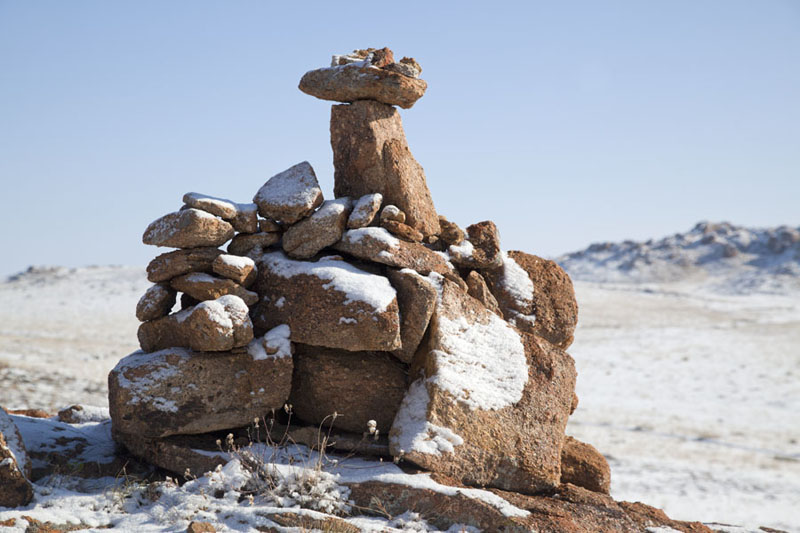 Picture of Small pile of stones covered by snow near a cave at Baga Gazryn ChuluuBaga Gazryn Chuluu - Mongolia