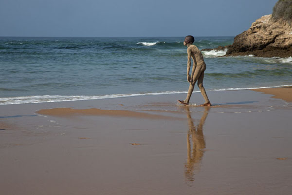 Picture of Guy covered in sand walking towards the surfTofo - Mozambique
