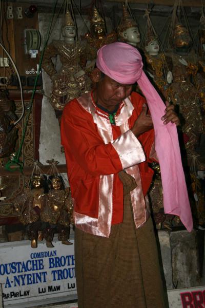 Picture of Moustache Brothers (Myanmar): Lu Zaw of the Moustache Brothers getting his pink turban ready
