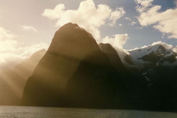 Picture of Play of light and shadow over between sun and mountains.Milford Sound - New Zealand