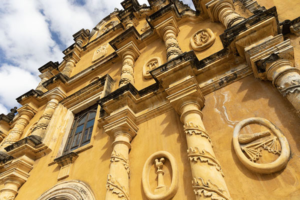 Picture of Recolección church of León has a baroque facade with several emblems