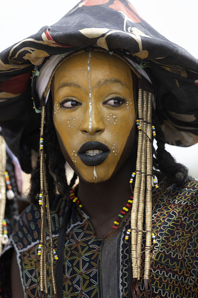 Foto van Wodaabe man with yellow painted face at the Gerewol festivalGerewol - Niger