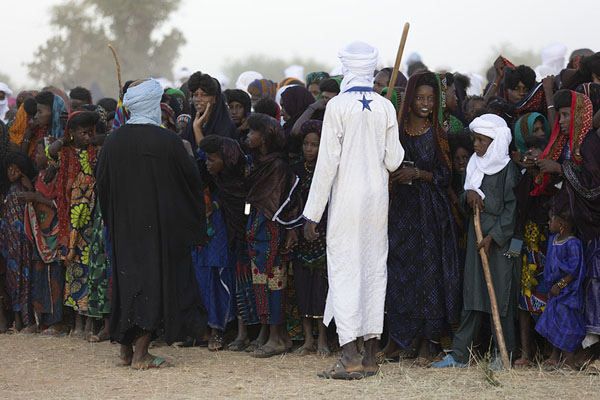 Men trying to keep the curious audience under control | Géréwol | Niger