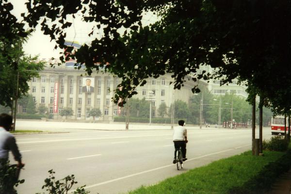 Picture of One of the few cyclist with in the background the picture of the Late LeaderNorth Korea - North Korea