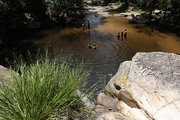 Picture of People playing in the pool at the foot of the biggest waterfall of Ybycui National Park - Paraguay - Americas