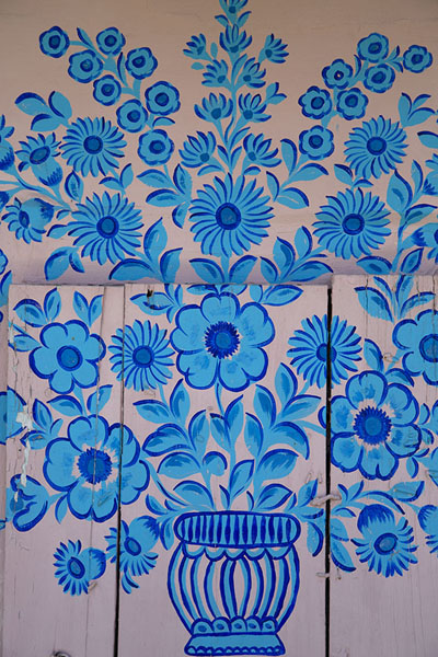 Close-up of blue flowers painted on a wall of a wooden house in Zalipie | Casas pintadas de Zalipie | Polonia