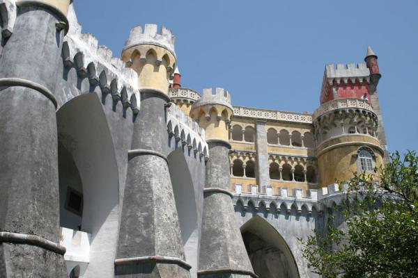 Foto van Arches, turrets and towers in the typical colours of Palace of PenaSintra - Portugal