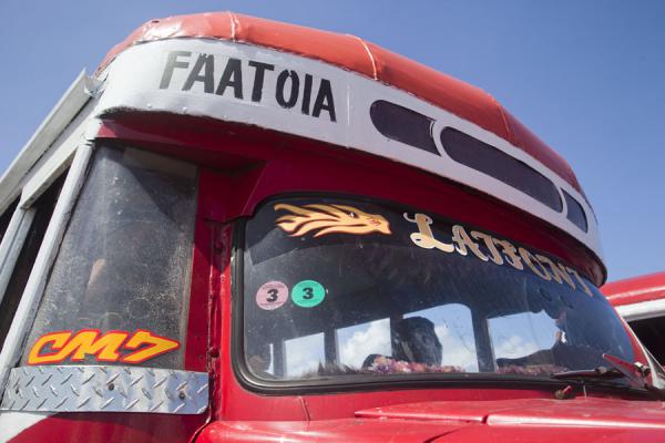 Picture of Samoan buses (Samoa): Front of a red bus at the bus station of Apia