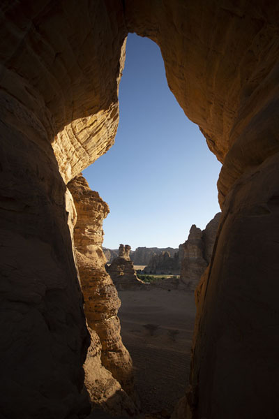 View through a huge opening in a rock near Elephant Rock | Al Ula rock formations | Saudi Arabia