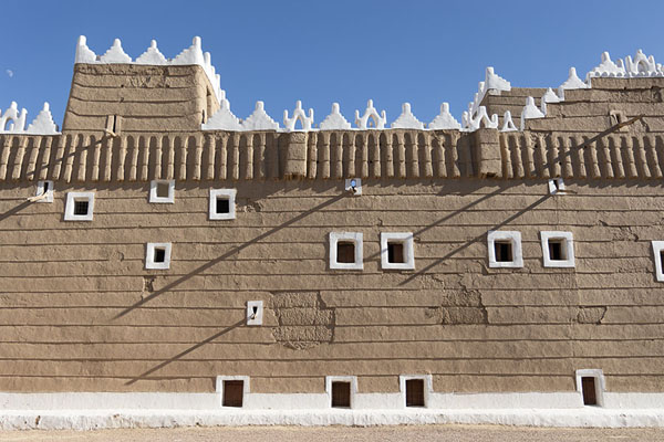 Picture of Wall of Emara Palace with white painted windows in an adobe wall - Saudi Arabia - Asia