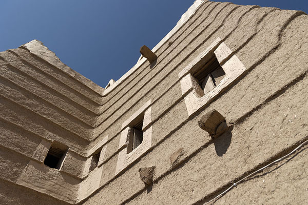 Looking up an adobe house in Najran | Historic adobe houses of Najran | Saudi Arabia