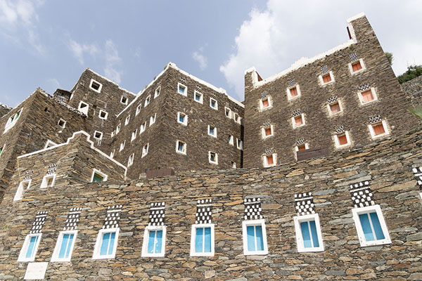 Picture of Looking up stone houses of Rijal Alma with colourful windowsRijal Alma - Saudi Arabia