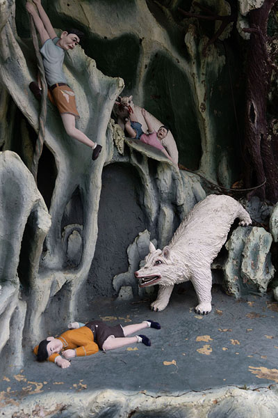 Picture of Boy playing dead while under attack by a bear: one of the many legendary dioramas in Haw Par Gardens