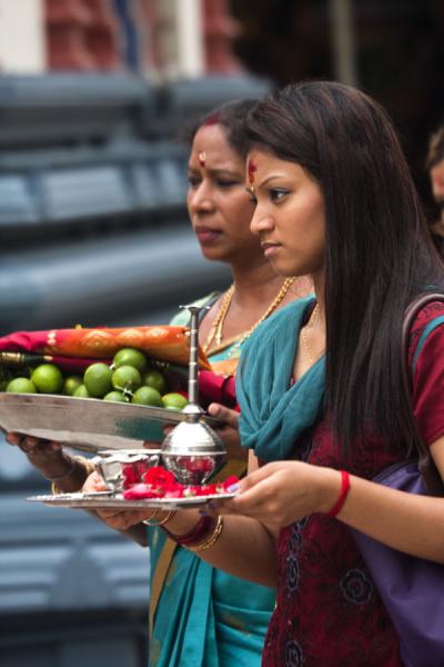 Picture of Two women in a small procession around Sri Mariamman temple