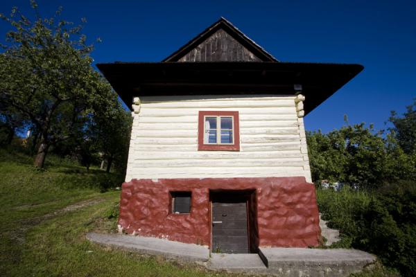Picture of Wooden house painted red and white in Vlkolínec