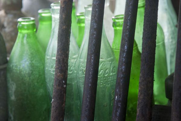 Coca-Cola and other bottles behind barrels of guns | Peter Joseph WW II museum | Solomon Islands