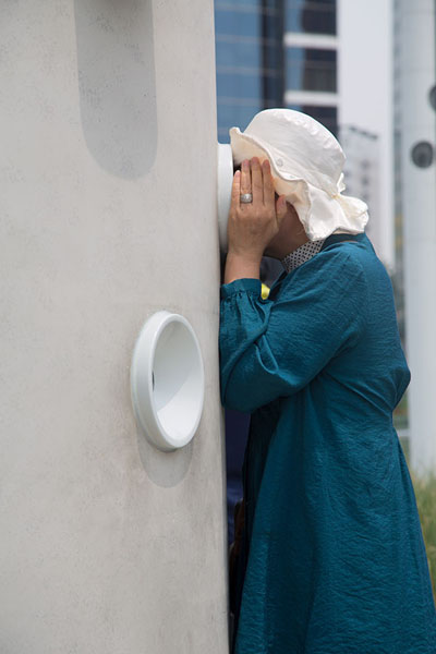 Korean woman looking through a peephole on the Seoullo 7017 walkway | Seoullo 7017 | South Korea