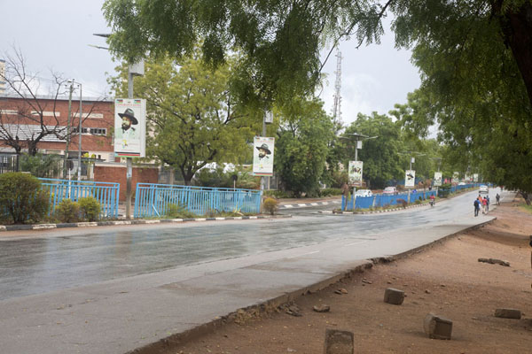 Picture of Juba Snapshots (South Sudan): Ministries Road, one of the main roads in Juba, with pictures of the hat-wearing President