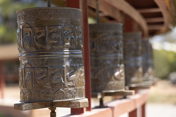Row of prayer wheels around the chorten of Sakya Tashi Ling monastery | Sakya Tashi Ling monastery | Spain