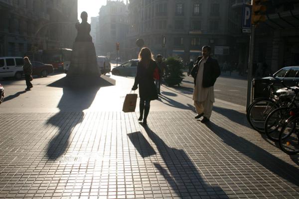 Picture of Sant Pere (Spain): Woman and her shadow walking the streets of Sant Pere