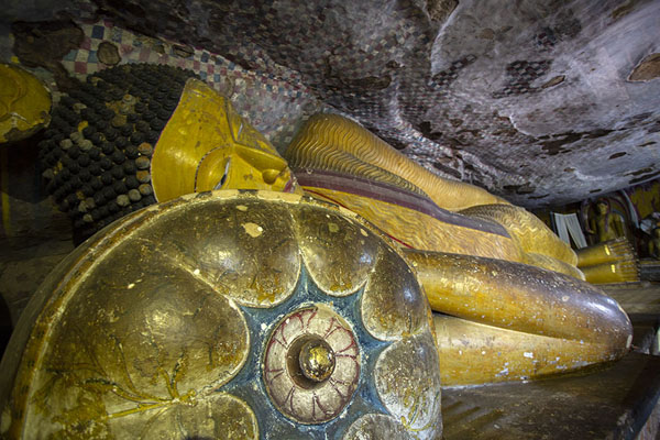 Reclining Buddha lying on a pillow in Maha Alut Viharaya cave | Dambulla Cave Temple | Sri Lanka