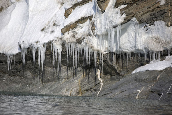Picture of Camp Millar (Svalbard and Jan Mayen): Snow and icicles on rocks near the beach at Camp Millar