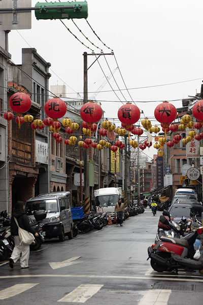 One section of Dihua Street with red and yellow lanterns hanging over it | Dihua Straat | Taiwan