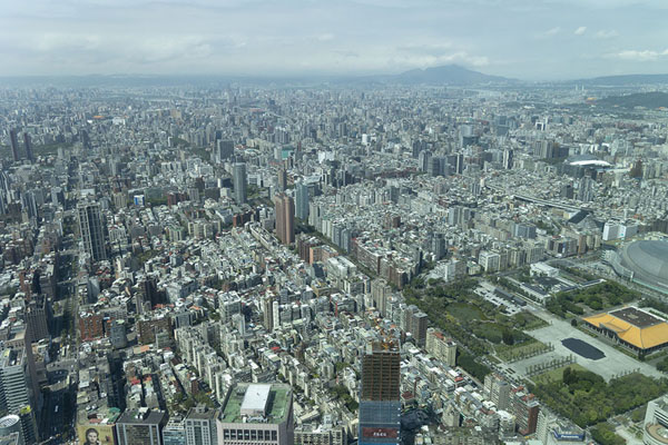 View over the city with mountains in the background from the 89th floor of Taipei 101 | Taipei 101 Tower | Taiwan