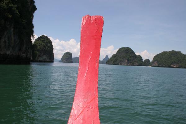 Picture of Red boat contrasting with islands of Phang Nga National Bay