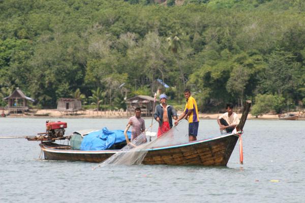 Fishermen taking in their nets from their boat at Ko Mook | Thai Fishermen | Thailand