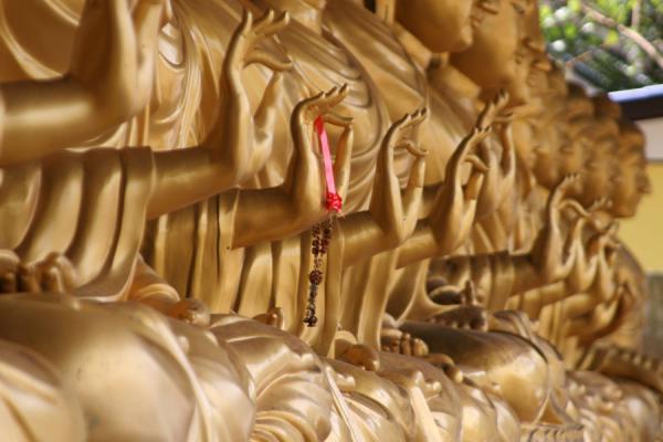 Detail of golden hands of Buddha | Wat Khao Sukim | Thailand