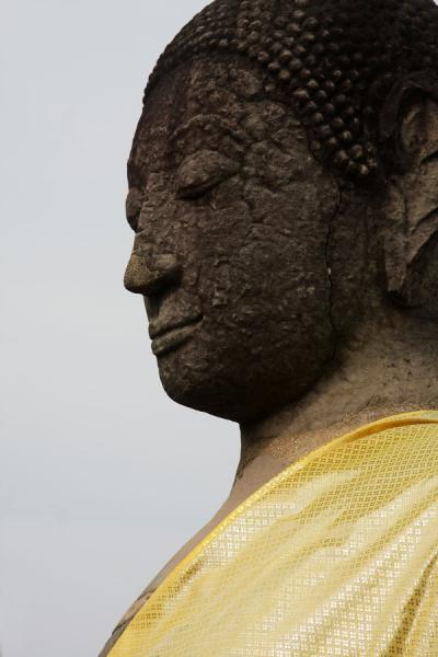 Head of a Buddha statue with yellow cloth | Wat Phra Mahathat | Thailand