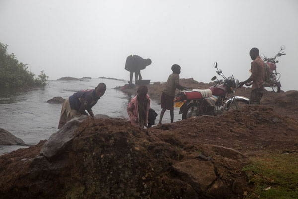 Picture of People washing their motorbike or clothes in the second waterfallSipi - Uganda