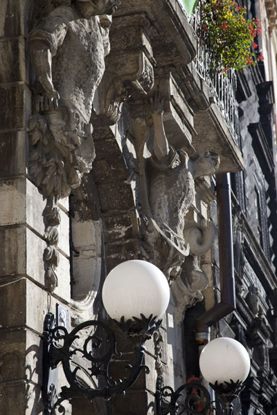 Picture of Ploshcha Rynok (Ukraine): Lanterns and sculptures adorning facades of houses on the eastern side of Market Square