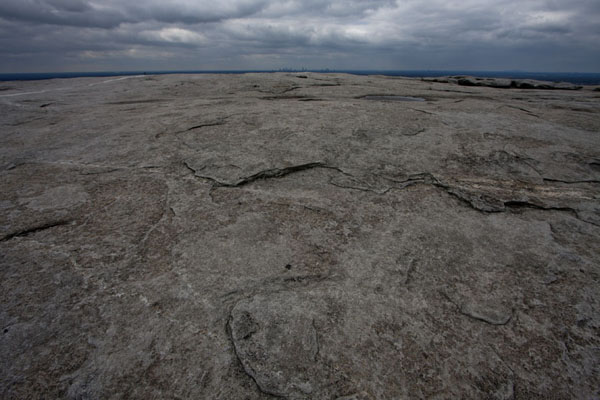 Picture of Rocky surface of Stone Mountain with the skyline of Atlanta in the background