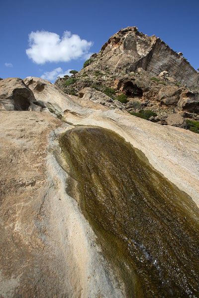 Looking up the rocks with water just below the infinity pool | Homhil infinity pool | Yemen