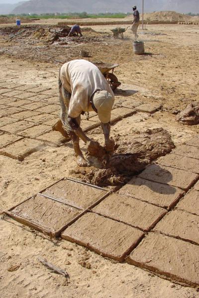 Picture of Wadi Hadramawt (Yemen): Man making bricks from mud in Wadi Hadramawt