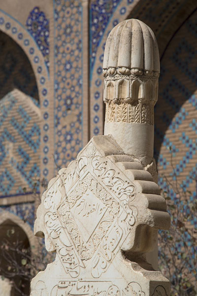 Close-up of tombstones with decorated wall in the background, Afghanistan