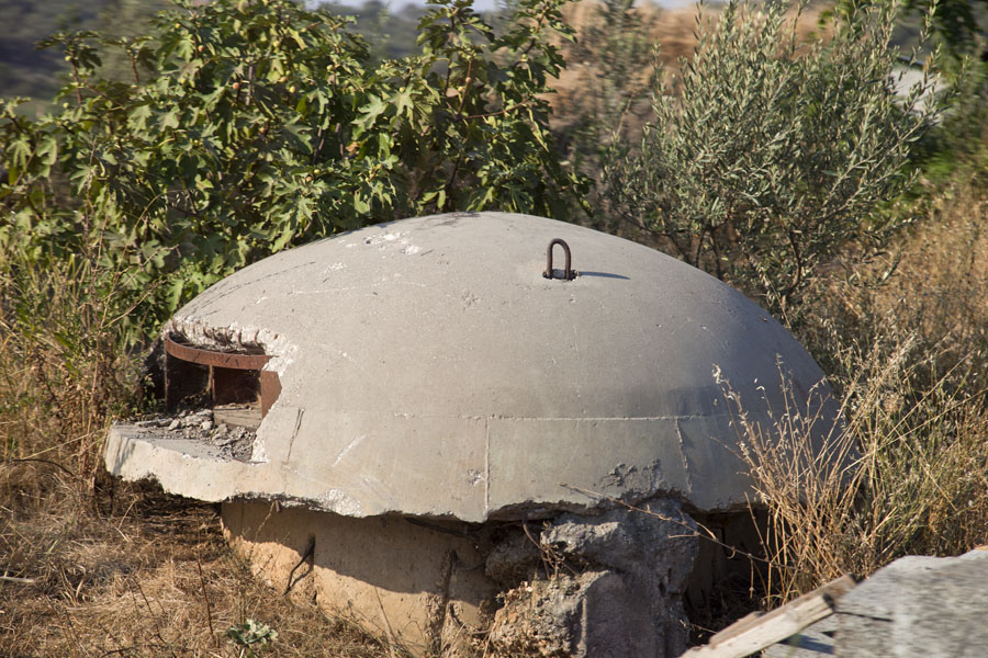 Concrete bunker between the bushes behind the beach of Borsh, Albania