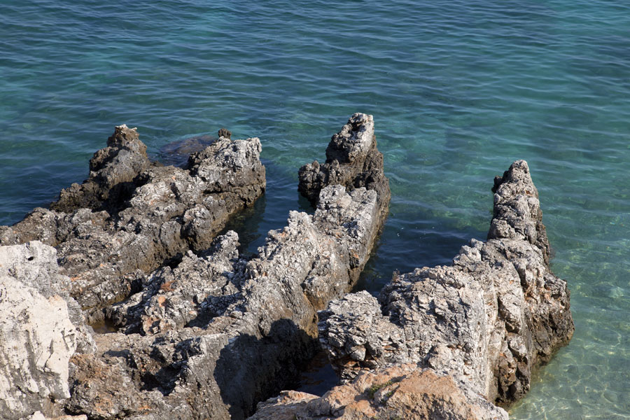 Rocky formation in the sea at Ksamil, Albania Blue and green waters around the rocks of Ksamil, Albania