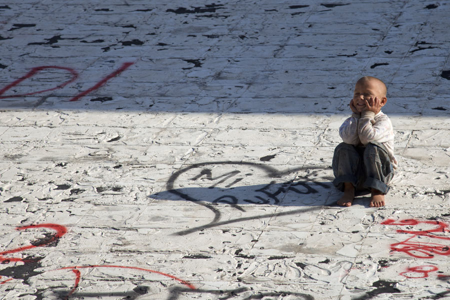 Boy sitting on the slope of the pyramid, Tirana Pyramid, Albania