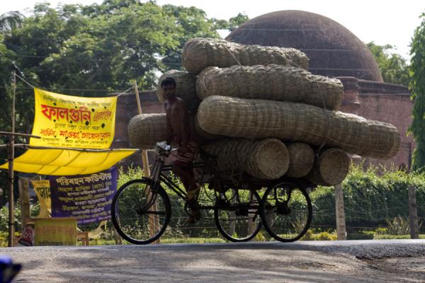 Bangladeshi transporting a big amount of baskets on his bike, Bangladesh