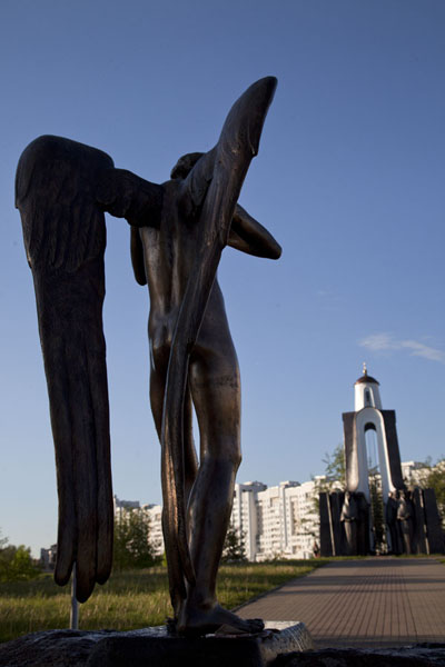 The weeping angel facing the chapel on the Island of Tears, Belarus
