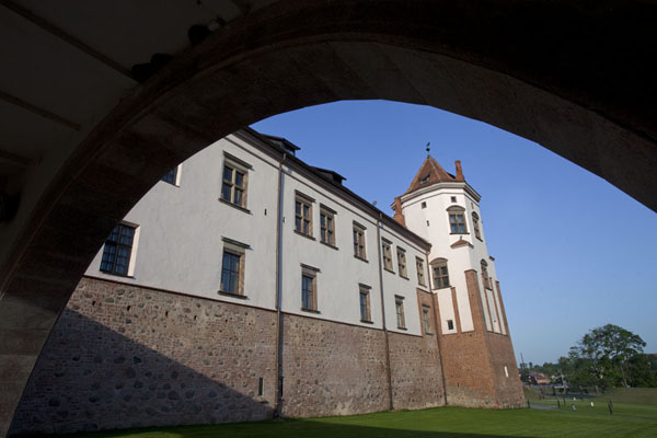 Picture of Looking at one of the towers of Mir castle seen from under an arch in the bridgeMir - Belarus