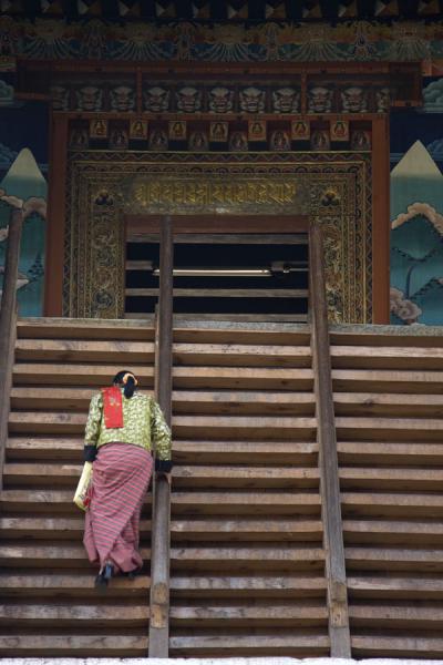 Bhutanese woman walking up the stairs to enter Punakha Dzong | Punakha Dzong | Bhutan