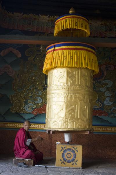 Monk turning the giant prayer wheel at the entrance | Punakha Dzong | Bhutan
