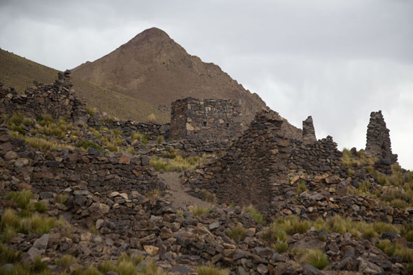 Mountain rising over the ruined buildings of San Antonio de Lípez, Bolivia Stone walls of San Antonio de Lípez with mountain behind, Bolivia