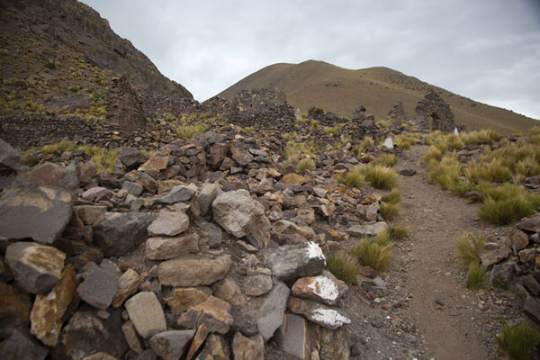 Path running between ruined buildings of the ghost town of San Antonio de Lípez, Bolivia