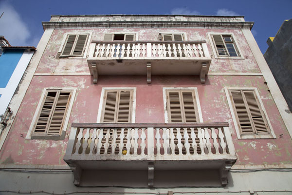 Looking up a pink colonial house in the centre of Mindelo, Cabo Verde