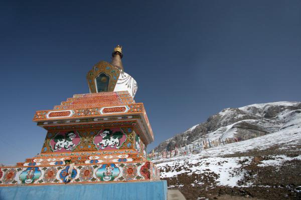 Stupa and snow covered mountain at Batang sky burial, China